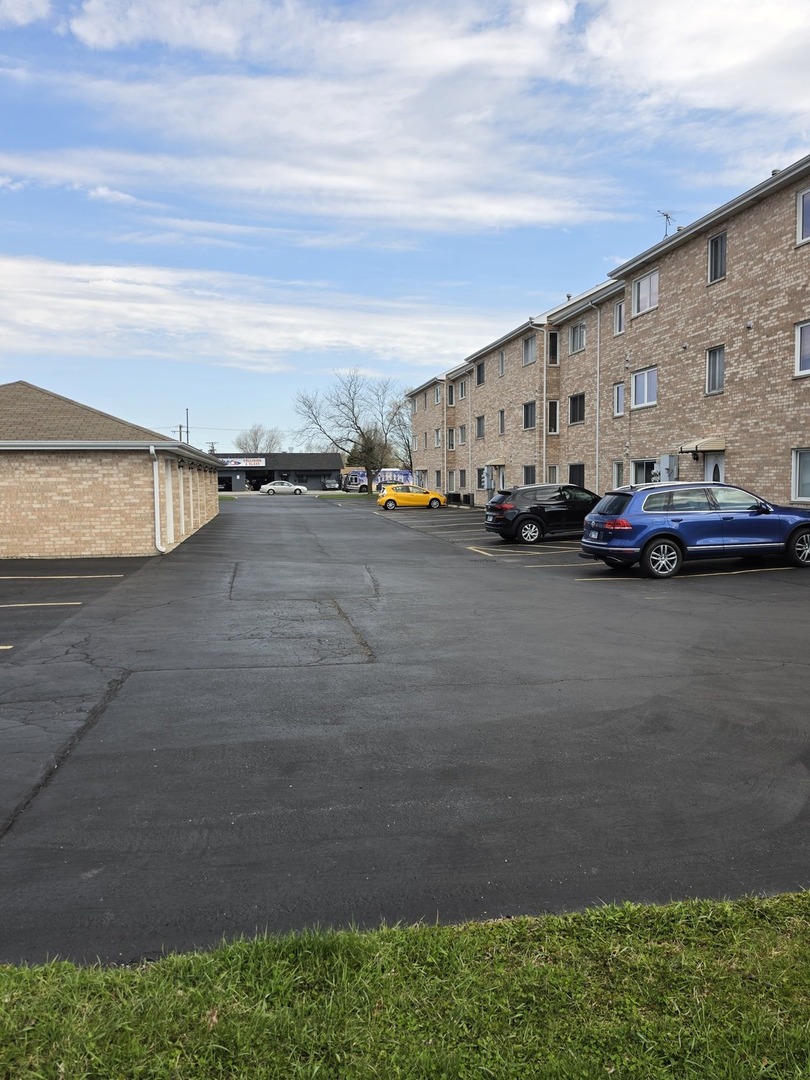 7902 Nagle Avenue, Unit 2S Burbank, IL 60459 - Photo 4 of 24 a view of city street with a car parked in front of it