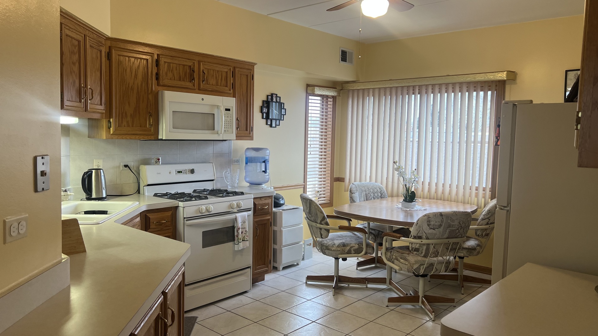 7902 Nagle Avenue, Unit 2S Burbank, IL 60459 - Photo 8 of 24 a kitchen with a stove a sink and a refrigerator