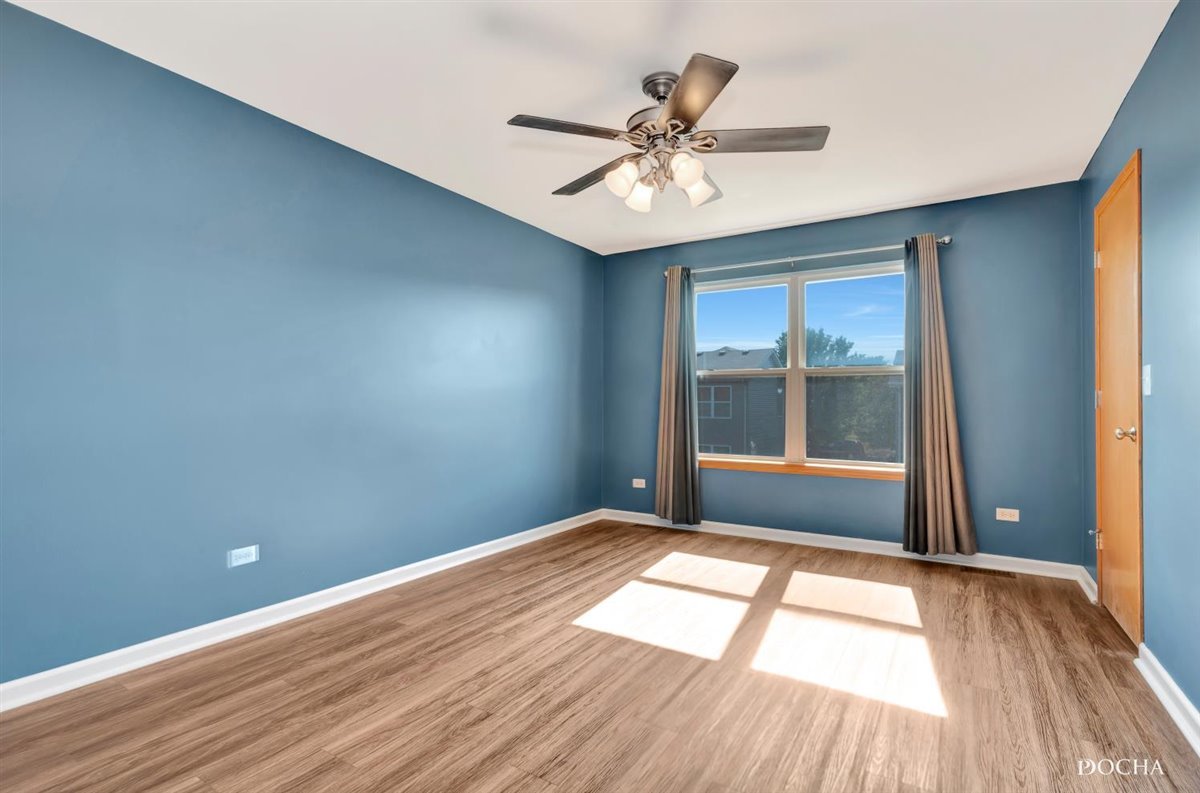 3715 Harms Road Joliet, IL 60435 - Photo 25 of 28 a view of empty room with wooden floor and fan