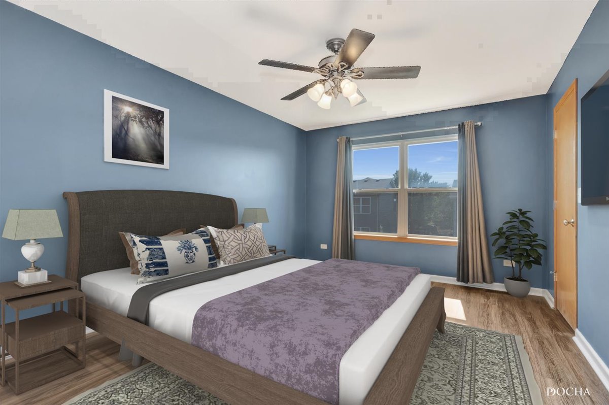 3715 Harms Road Joliet, IL 60435 - Photo 26 of 28 a bedroom with a large bed and a chandelier