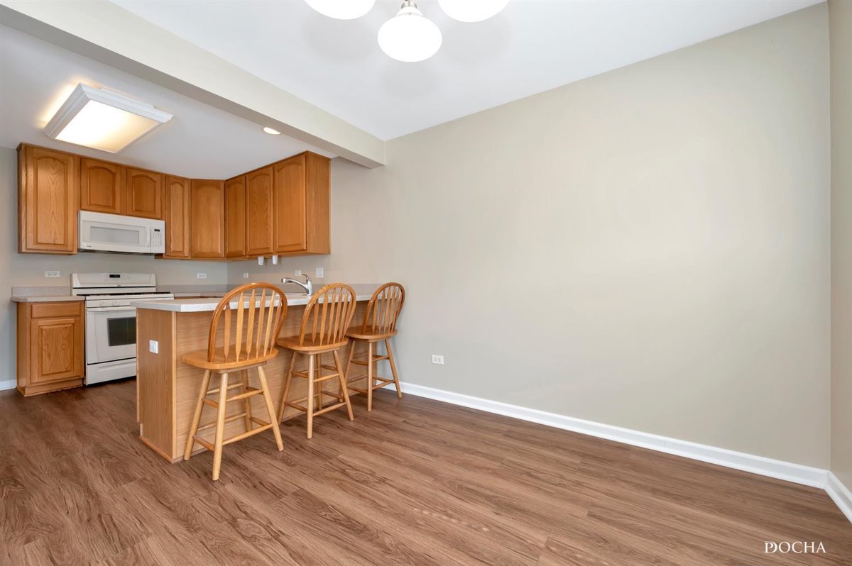 3715 Harms Road Joliet, IL 60435 - Photo 7 of 28 a dining room with furniture and wooden floor