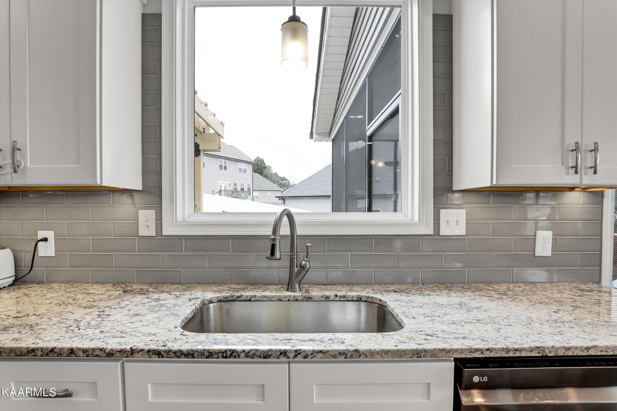 6043 Pembridge Road Knoxville, TN 37912 - Photo 15 of 49 a kitchen sink with granite countertop white cabinets and a sink
