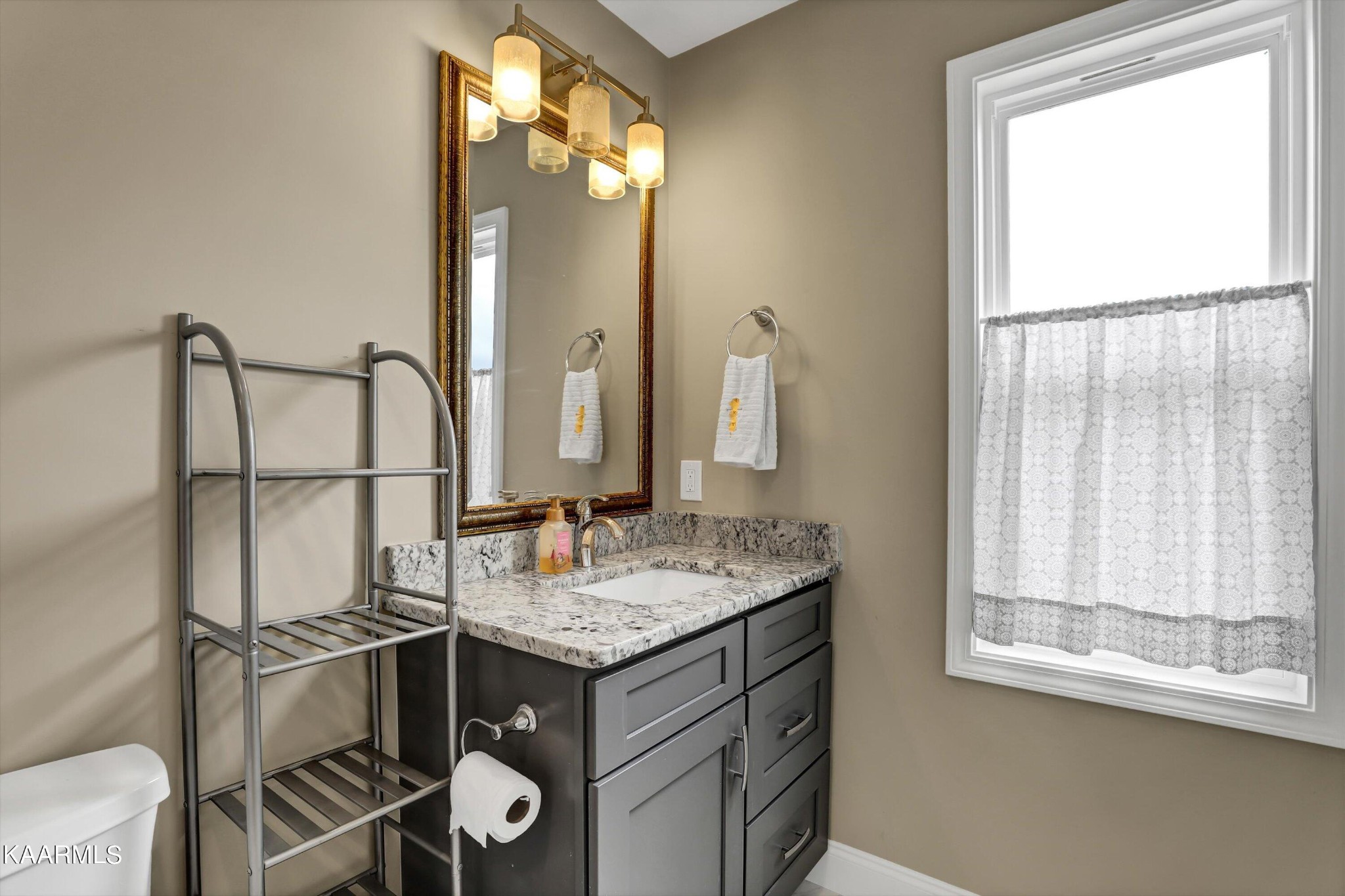 6043 Pembridge Road Knoxville, TN 37912 - Photo 32 of 49 a bathroom with a sink vanity and a mirror