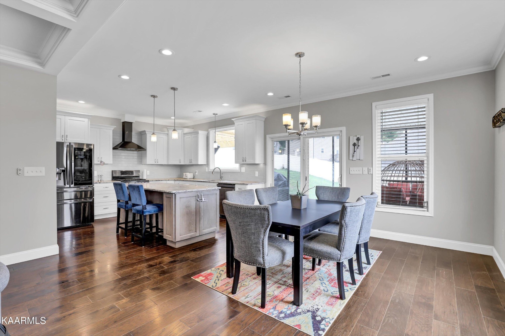 6043 Pembridge Road Knoxville, TN 37912 - Photo 10 of 49 a view of a dining room and livingroom with furniture wooden floor a chandelier