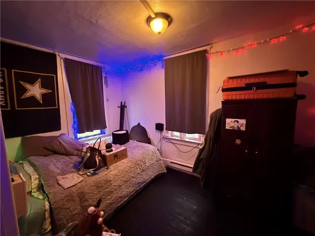 a bedroom with bed and furniture