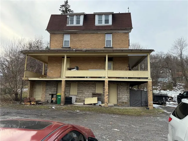 a front view of a house with parking space