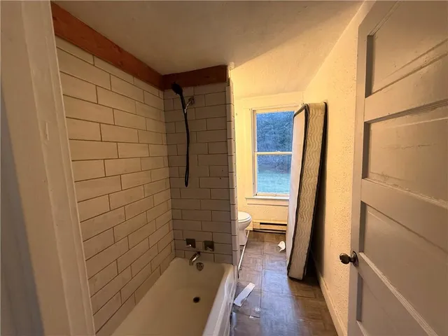 a bathroom with a tub and a shower