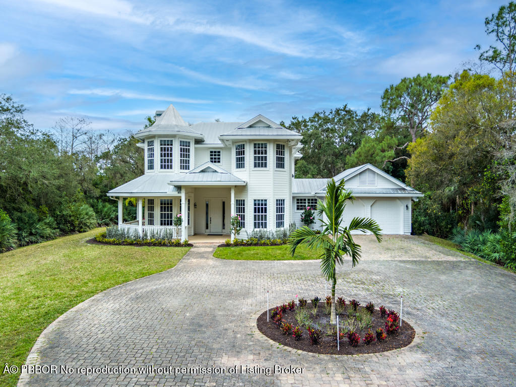 1001 Southeast Ranch Road Northeast Jupiter, FL 33478 - Photo 27 of 32 a front view of a house with a yard