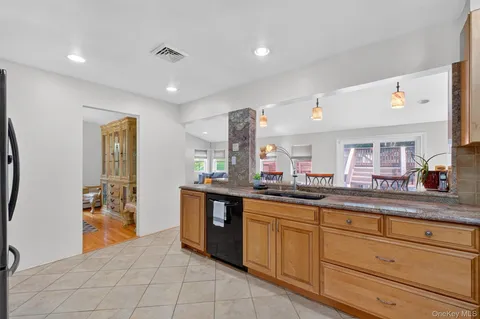 a kitchen with granite countertop a sink and cabinets