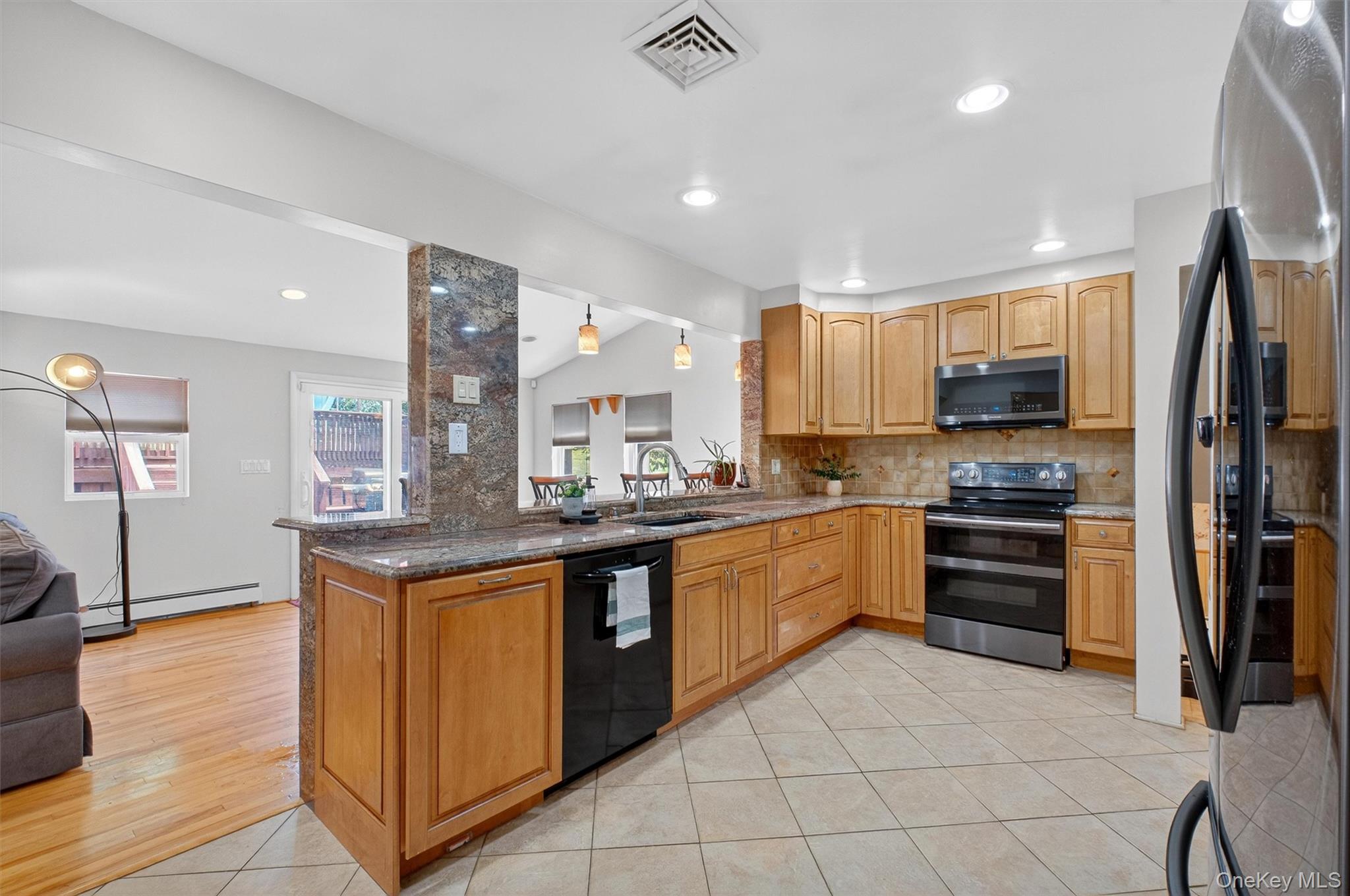 5 Verplanck Avenue Hopewell Junction, NY 12533 - Photo 16 of 50 a kitchen with stainless steel appliances granite countertop a stove top oven a sink and a refrigerator