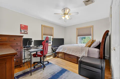 a bedroom with furniture and a wooden floor