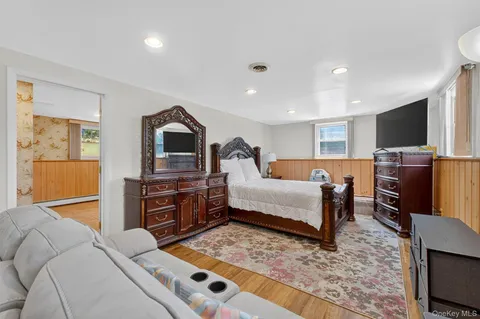 a bedroom with furniture and a flat screen tv