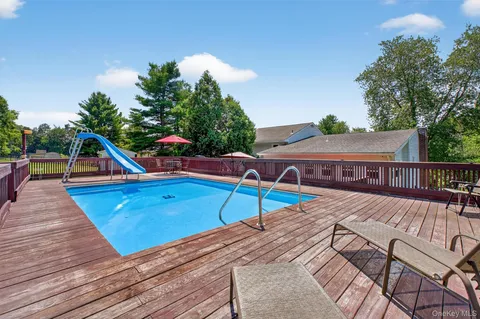 a view of house with backyard and sitting area
