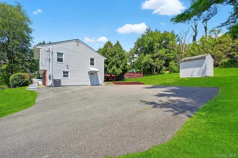a view of a house with a yard and a garage