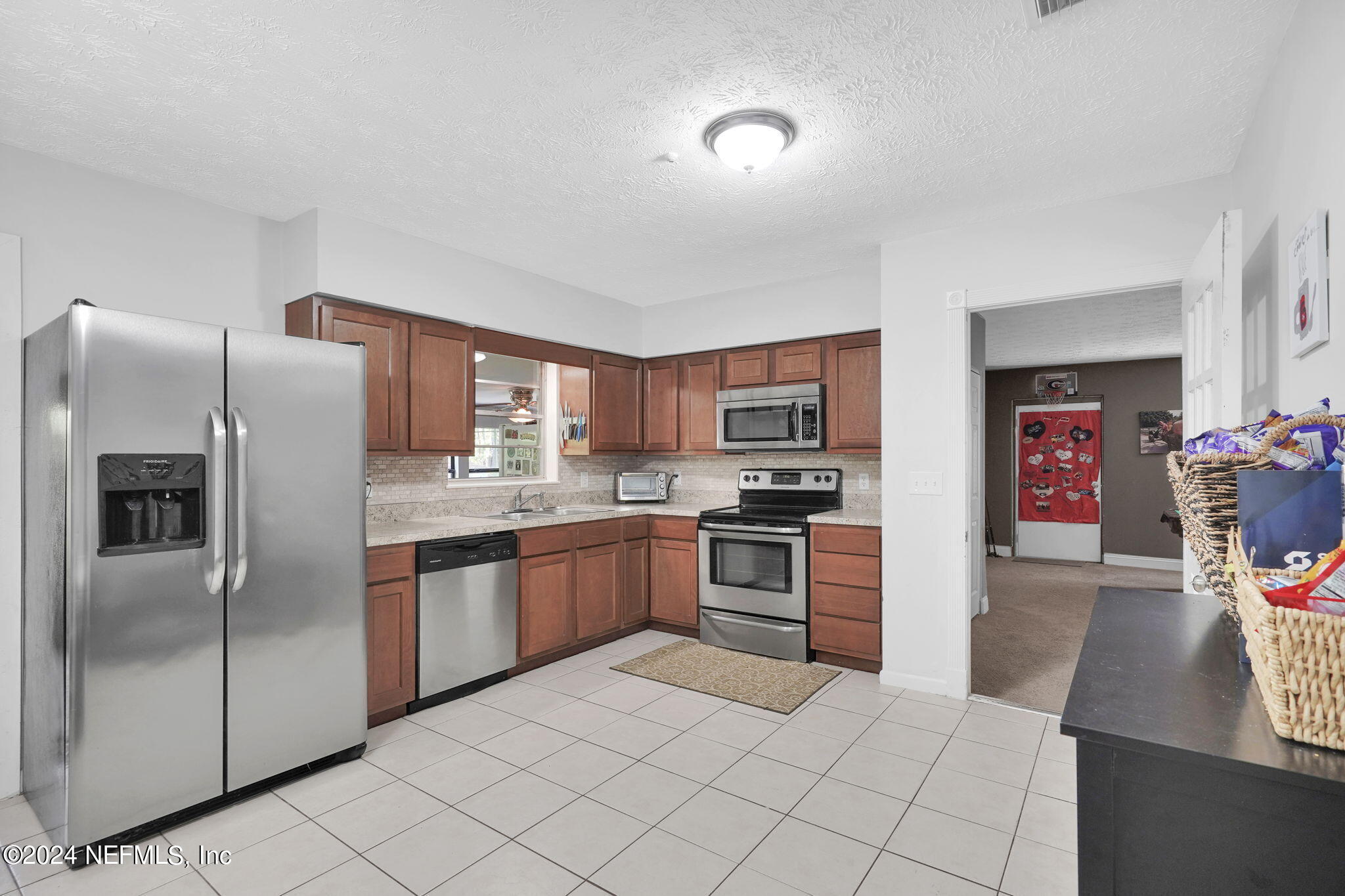 54371 Hazel Jones Road Callahan, FL 32011 - Photo 12 of 36 a kitchen with stainless steel appliances granite countertop a refrigerator and a stove top oven
