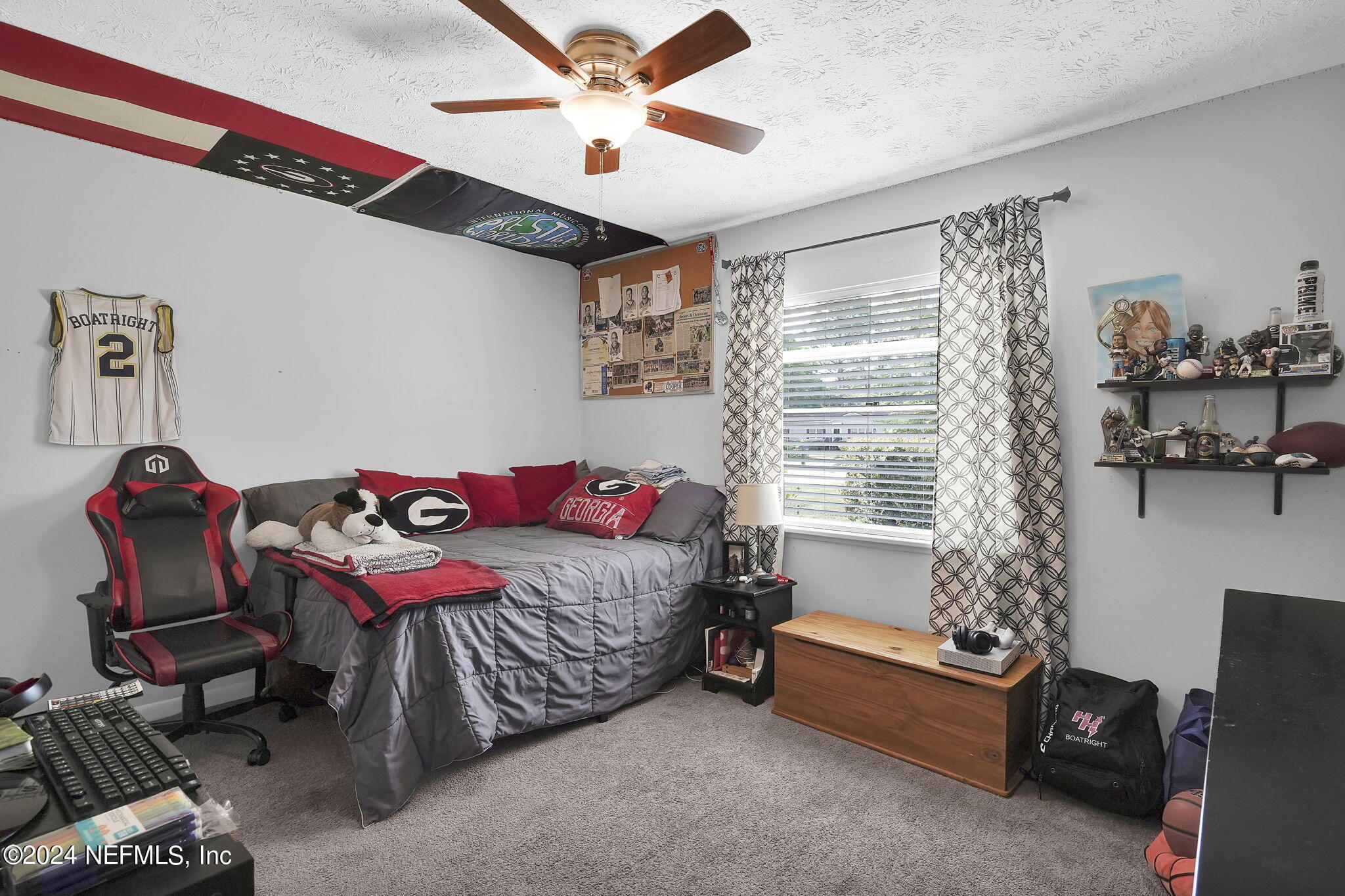 54371 Hazel Jones Road Callahan, FL 32011 - Photo 21 of 36 a bedroom with a bed and a chandelier