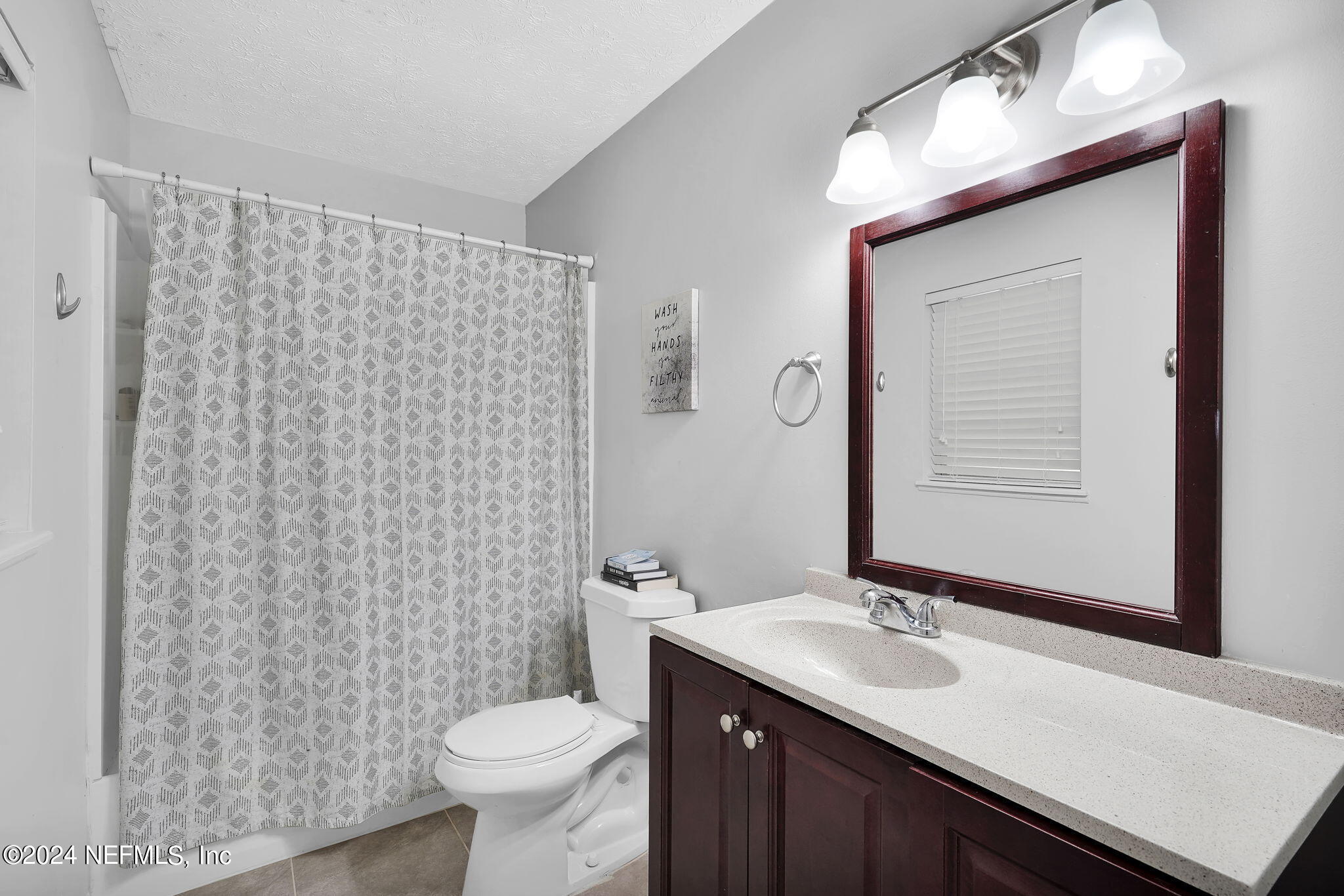 54371 Hazel Jones Road Callahan, FL 32011 - Photo 25 of 36 a bathroom with a sink a toilet and shower