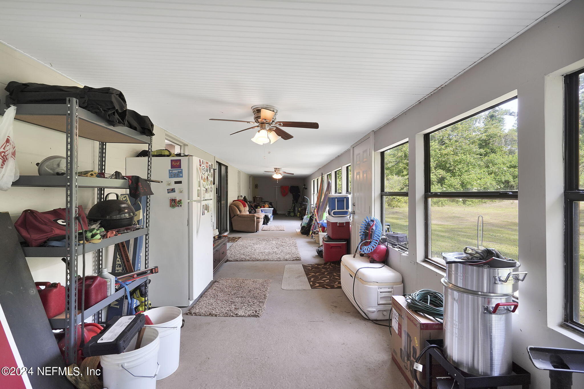 54371 Hazel Jones Road Callahan, FL 32011 - Photo 27 of 36 a living room with furniture and a floor to ceiling window