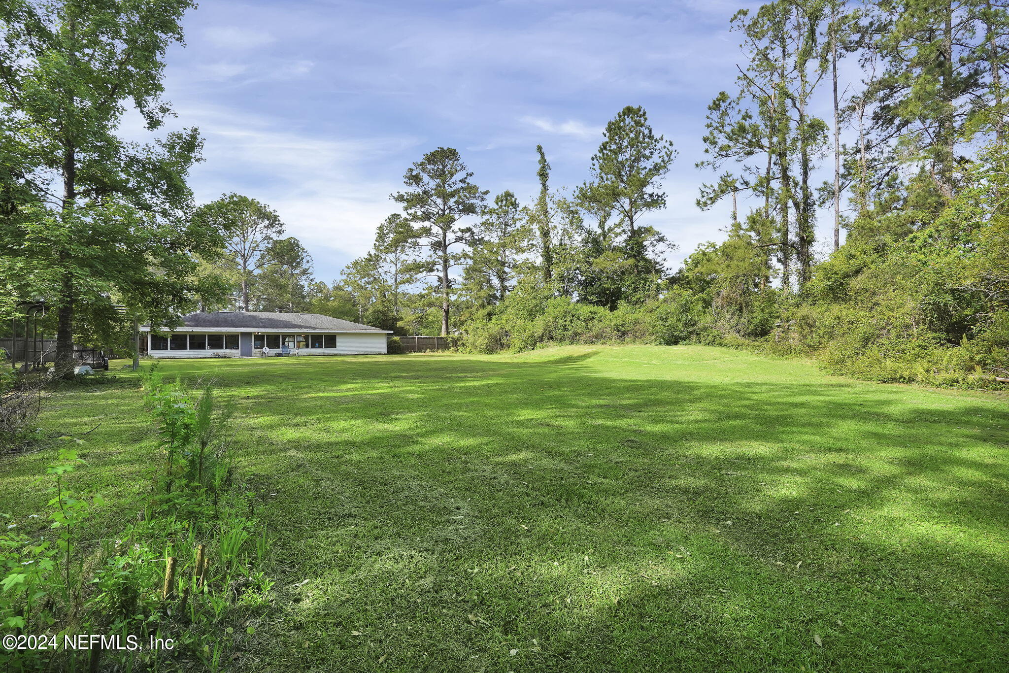54371 Hazel Jones Road Callahan, FL 32011 - Photo 32 of 36 a view of a grassy field with trees around