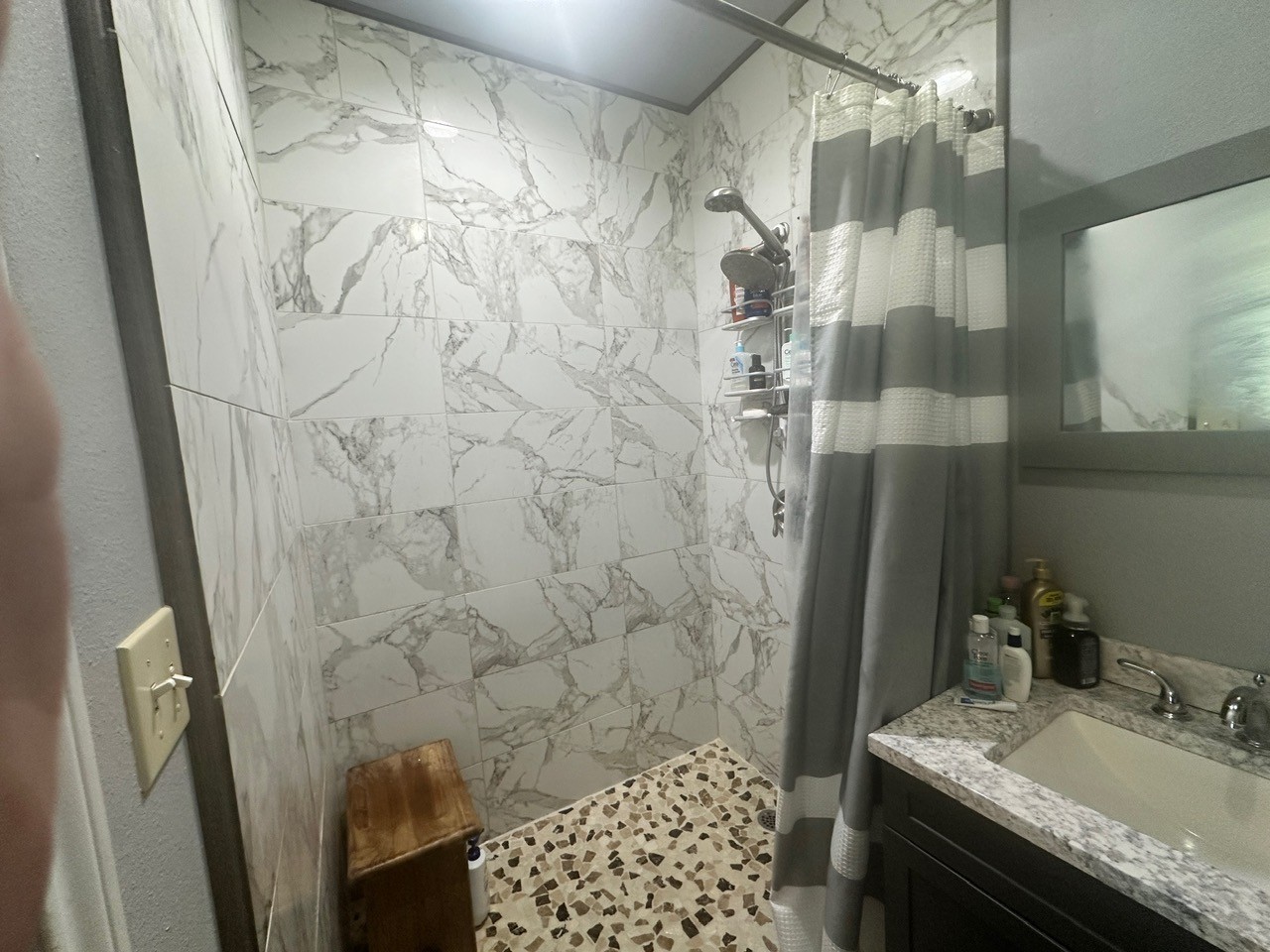 109 Foreman Trinity, TX 75862 - Photo 11 of 17 a bathroom with a granite countertop shower a sink and a mirror