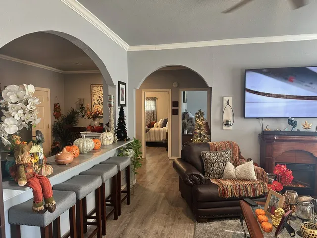 a living room with furniture a fireplace and a flat screen tv
