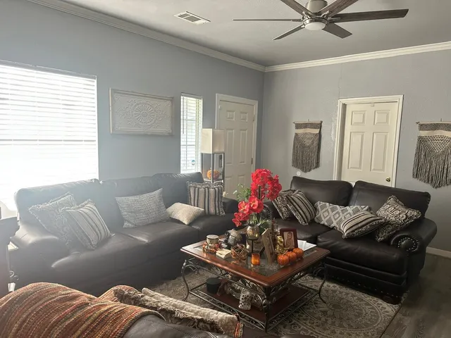 a kitchen with stainless steel appliances a table and chairs in it