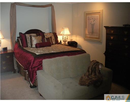 36 Brookside Road Edison, NJ 08817 - Photo 11 of 19 a bedroom with a bed and a lamp on dresser