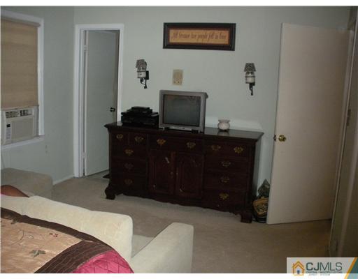 36 Brookside Road Edison, NJ 08817 - Photo 12 of 19 a bedroom with a bed and a desk