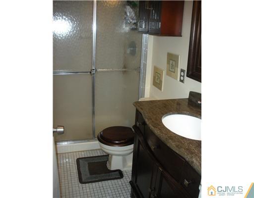 36 Brookside Road Edison, NJ 08817 - Photo 13 of 19 a bathroom with a sink a toilet and shower