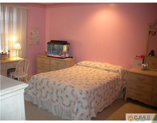 36 Brookside Road Edison, NJ 08817 - Photo 14 of 19 a bedroom with a bed and a dresser