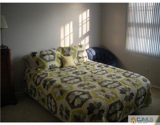 36 Brookside Road Edison, NJ 08817 - Photo 15 of 19 a bed sitting in a bedroom next to a window
