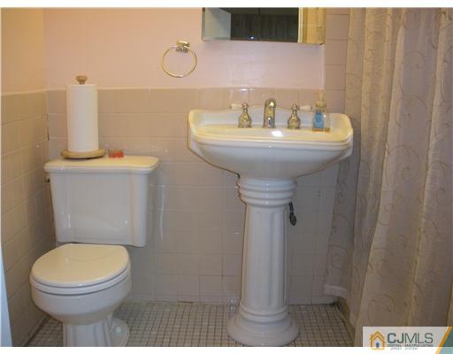 36 Brookside Road Edison, NJ 08817 - Photo 17 of 19 a bathroom with a sink a toilet and a mirror