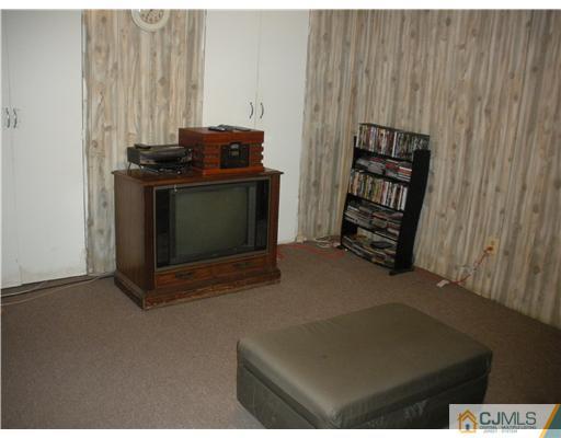 36 Brookside Road Edison, NJ 08817 - Photo 18 of 19 a view of an empty room with furniture and a fireplace