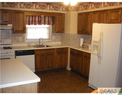 36 Brookside Road Edison, NJ 08817 - Photo 5 of 19 a kitchen with a sink a stove a refrigerator and cabinets