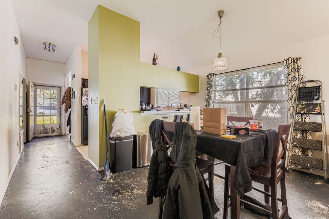 4705 Fallenash Drive Austin, TX 78725 - Photo 3 of 11 Dining space featuring concrete flooring and baseboards