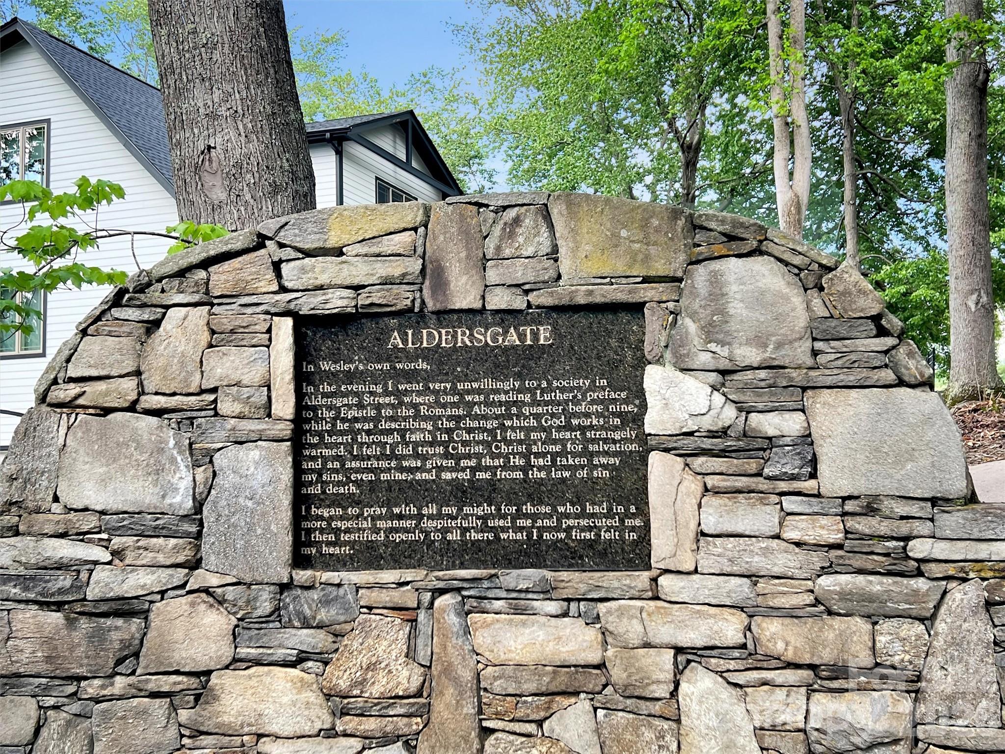 186 Aldersgate Road Waynesville, NC 28786 - Photo 14 of 14 a view of a brick house with large windows and a table and chairs