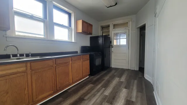 a kitchen with a refrigerator and window