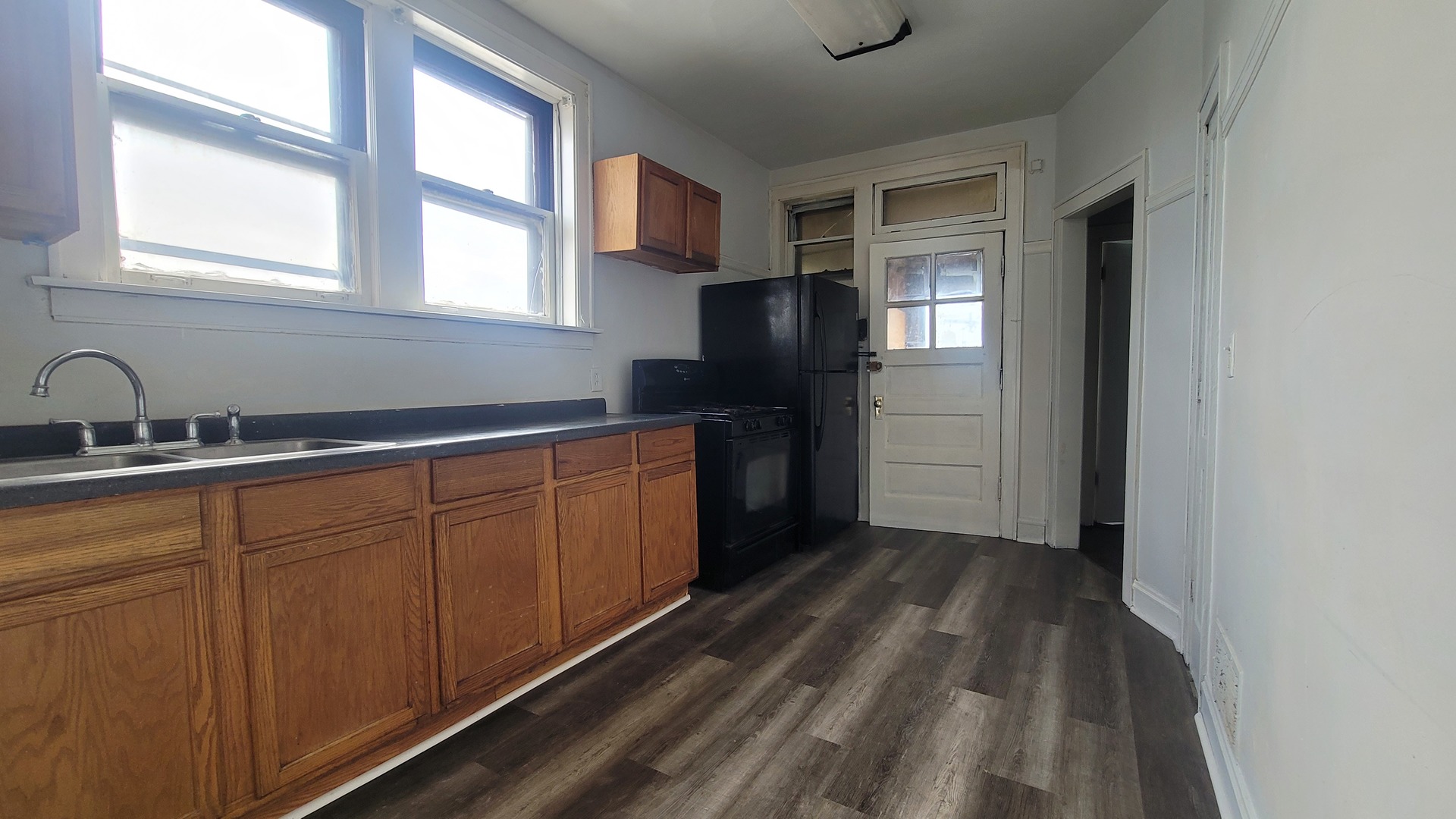 7842 South Bennett Avenue, Unit 2 Chicago, IL 60649 - Photo 4 of 10 a kitchen with a refrigerator and window