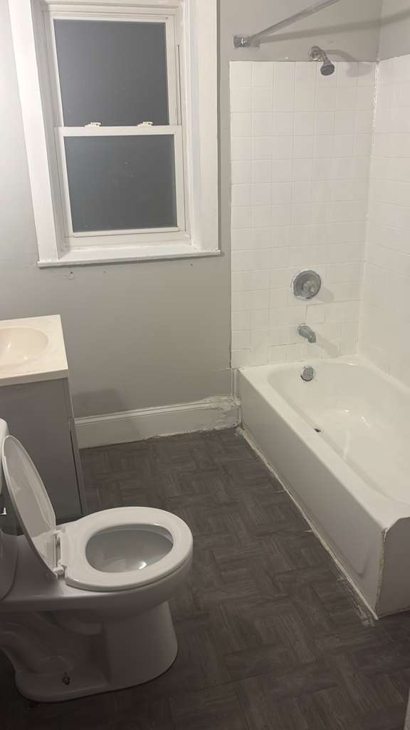 7842 South Bennett Avenue, Unit 2 Chicago, IL 60649 - Photo 6 of 10 a white toilet sitting next to a bath tub