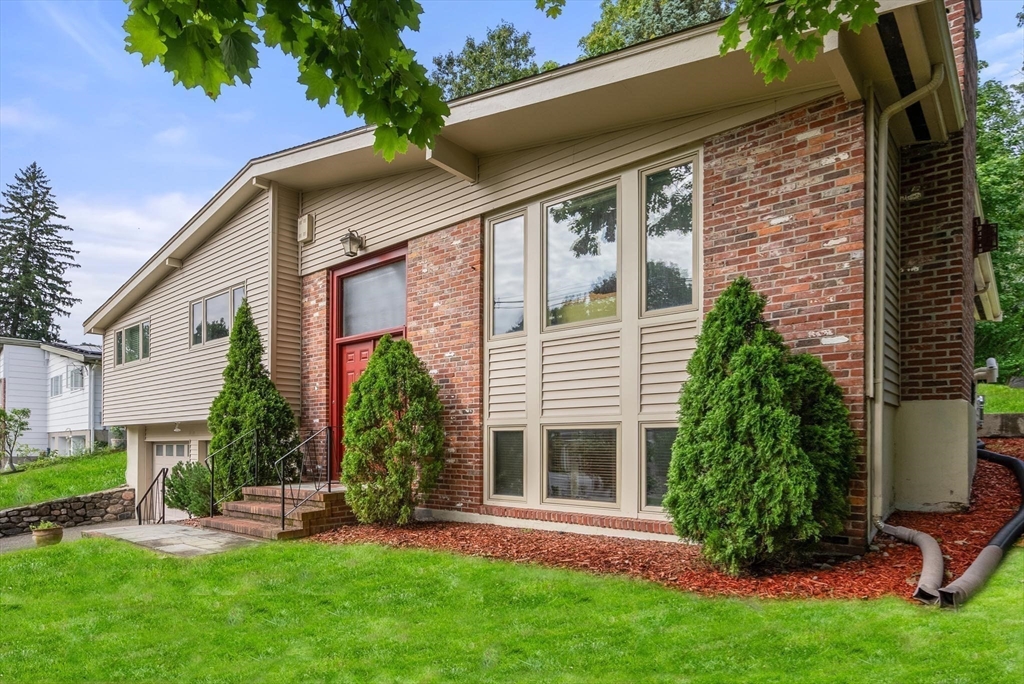 a view of a house with a yard and sitting area