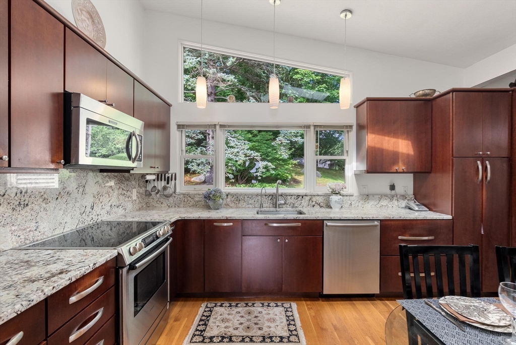 54 Clark Street Newton, MA 02459 - Photo 11 of 34 a kitchen with stainless steel appliances granite countertop a sink stove and refrigerator
