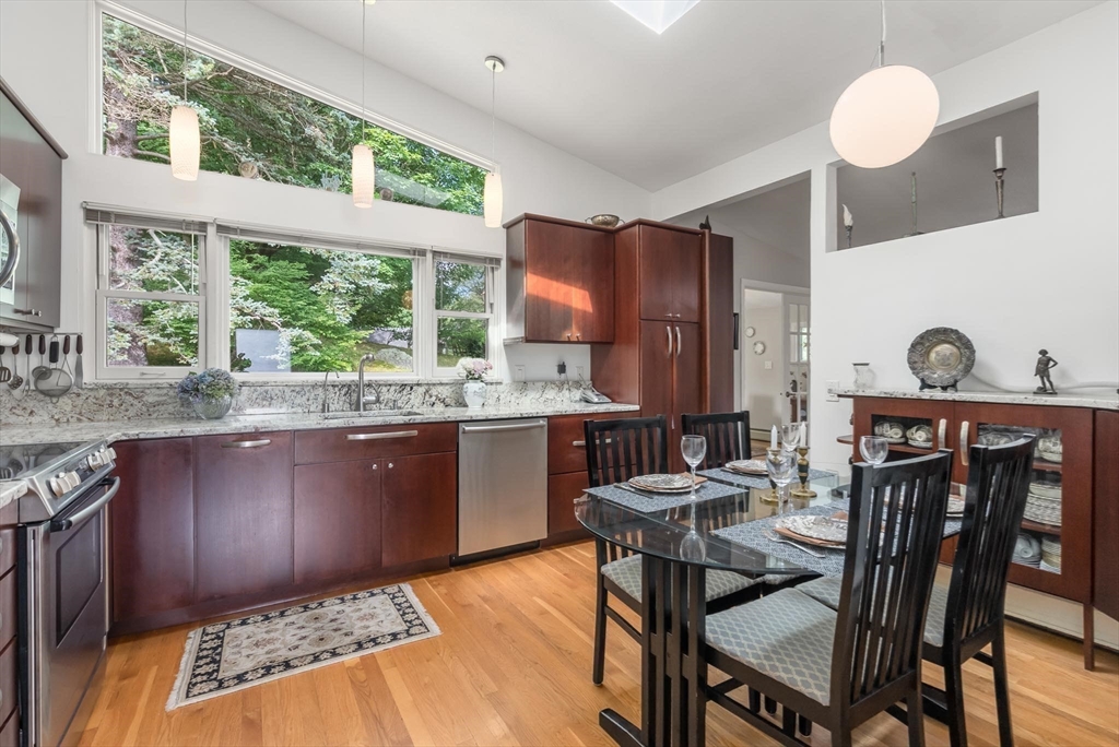 54 Clark Street Newton, MA 02459 - Photo 13 of 34 a kitchen with a stove a sink a dining table and chairs