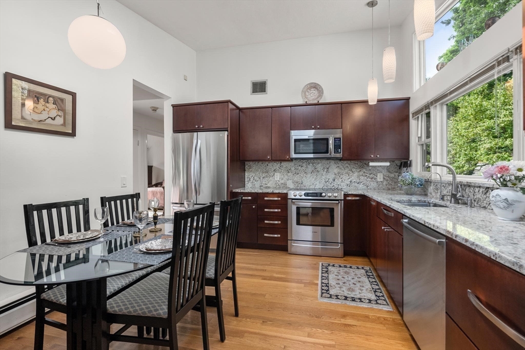 54 Clark Street Newton, MA 02459 - Photo 15 of 34 a kitchen with stainless steel appliances granite countertop a stove a sink and a refrigerator