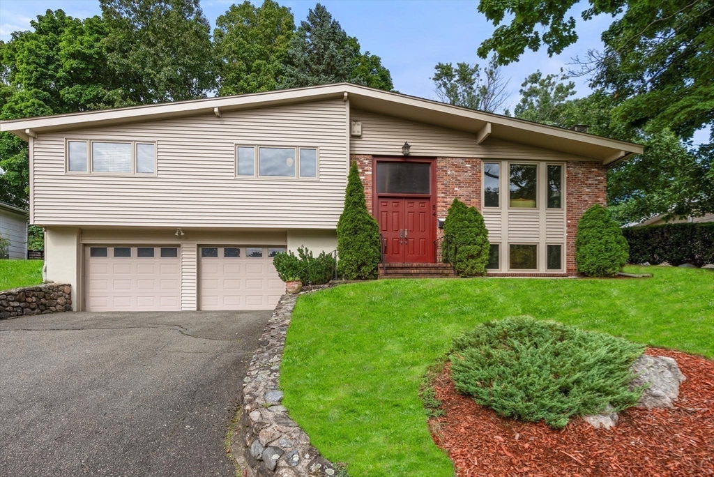 54 Clark Street Newton, MA 02459 - Photo 2 of 34 a front view of a house with a garden and plants
