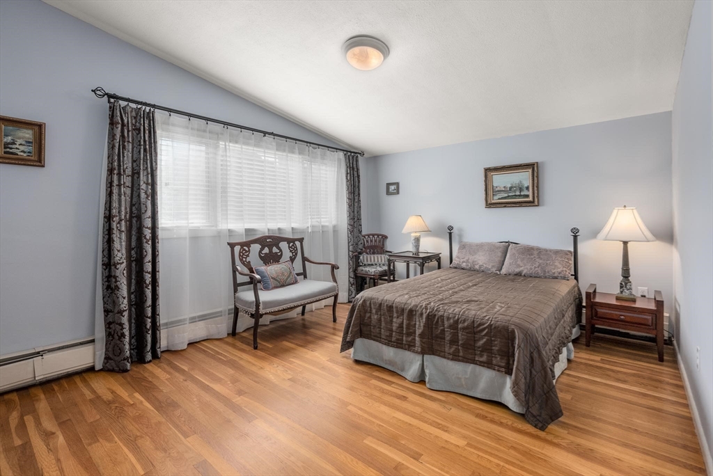 54 Clark Street Newton, MA 02459 - Photo 22 of 34 a spacious bedroom with a bed and wooden floor