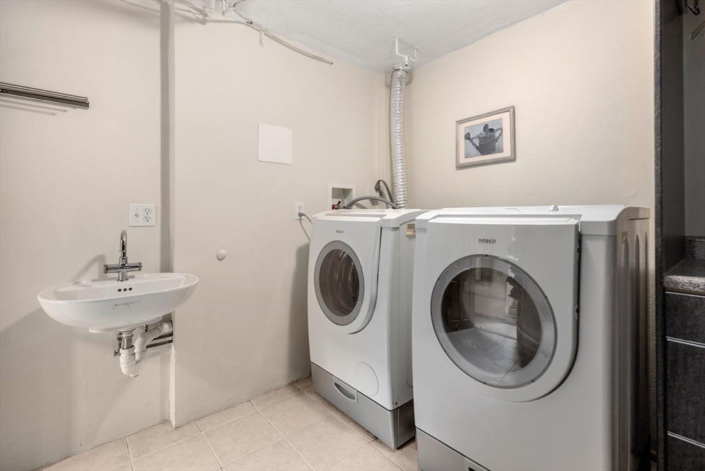 54 Clark Street Newton, MA 02459 - Photo 28 of 34 a utility room with sink dryer and washer