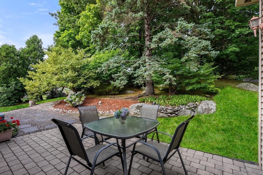 54 Clark Street Newton, MA 02459 - Photo 31 of 34 a view of patio with table and chairs potted plants with wooden fence