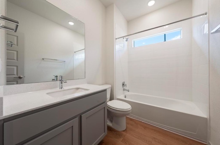 10805 Meris Lane Austin, TX 78754 - Photo 19 of 28 A well-appointed bathroom features a single vanity, a spacious bathtub, and bright recessed lighting.