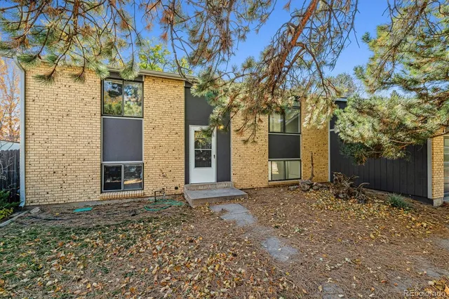 front view of a house with a large tree