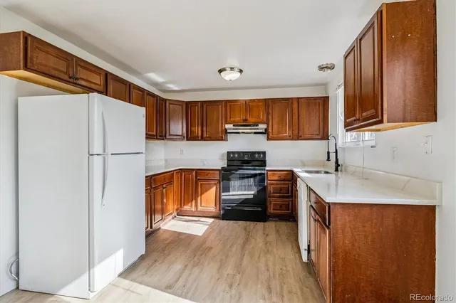 a kitchen with stainless steel appliances a refrigerator sink and cabinets